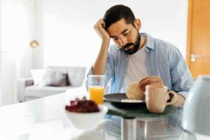 Man with anxiety disorders eating breakfast