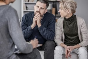 wife and husband during couples therapy with counselor