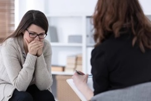 sad woman crying during individual therapy at professional clinic