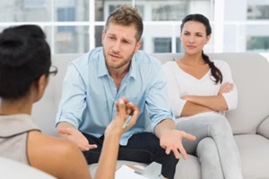 couple at therapy session with man talking to therapist