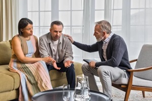 multiracial couple at family therapy, upset man