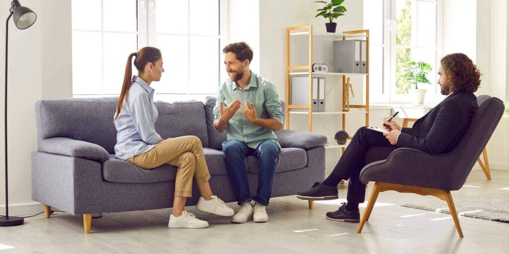 MD couple psychologist listens to conversation of married couple during therapy session