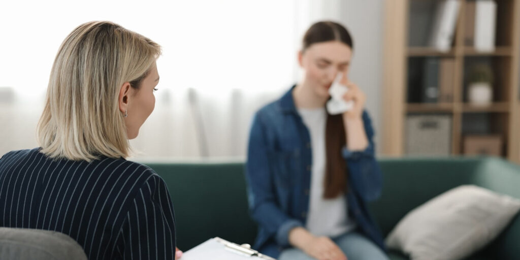 professional psychotherapist working with patient in office