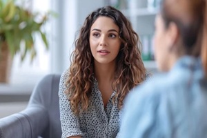 psychotherapy female psychologist having session with male patient at mental health clinic