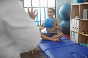 kid playing with therapist in his office