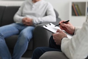 therapist taking notes of patient diagnostics