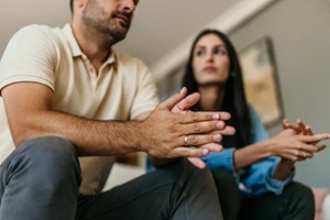 couple sitting on the couch trying to solve the problems at home in the living room