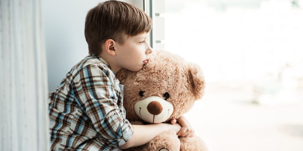 one child boy abandoned in an old abandoned house with a teddy bear