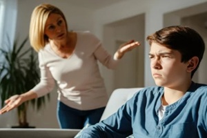 mother scolding teenage son at home frustrated teenager ignoring parent's reprimand