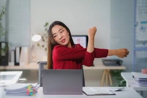 asian women doing stretching during work considering individual therapy