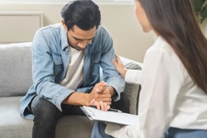 asian young man consulting with psychiatrist while patient counseling mental therapy problem with doctor at clinic