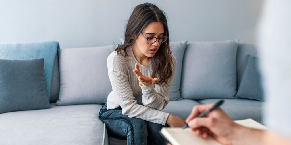 psychologist listening to woman in trouble during therapy session