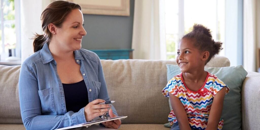 young girl talking with counselor at home