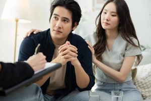 therapist providing emotional support to worried man during couple therapy session