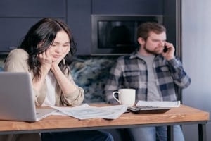 Woman Watching Documents- and Her Partner Busy on Phone before attending couples therapy in maryland
