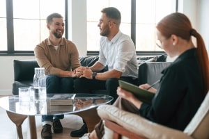 LGBT Couple Holding Hands in Office of A Therapist