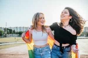 Young Trans Girls Laughing with LGBT Pride Flag