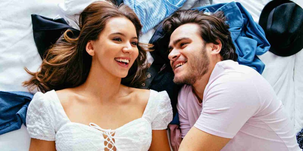 Couple Laying on Bed Having Sex Talk and Laughing
