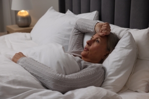 Woman Suffering from Night Sweating in Bed