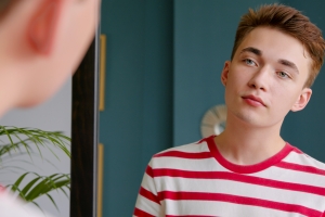 Young Queer Practicing Self Affirmations in Mirror