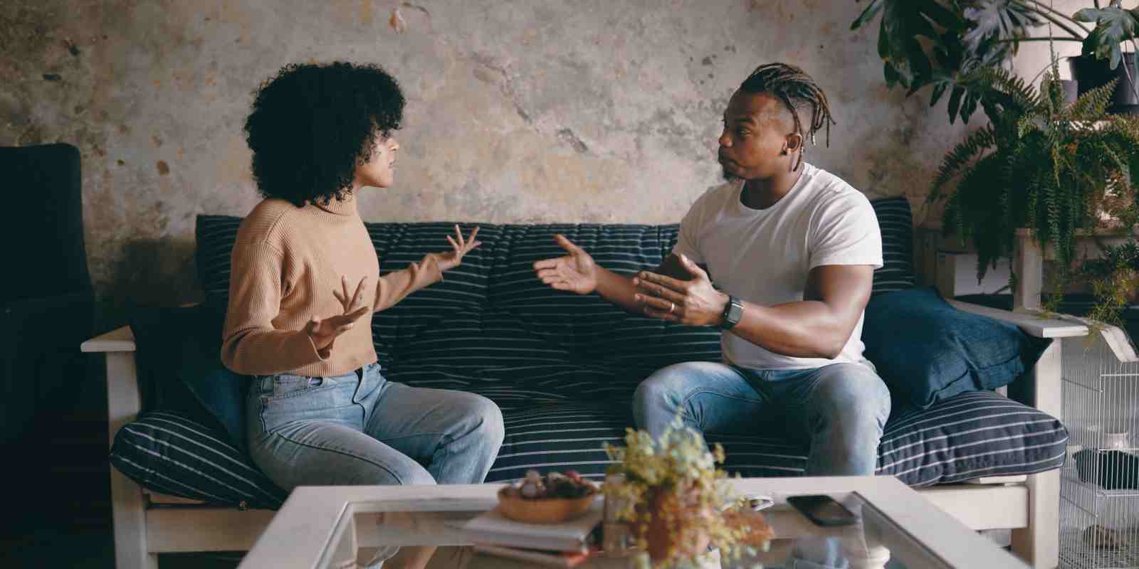 Couple Sitting on Sofa Arguing with Each Other