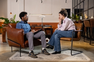 Male Therapist Talking to Sad Woman in Therapy Session