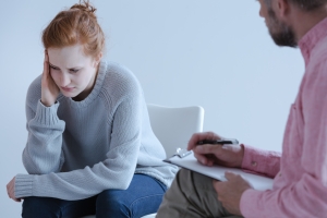 Stressed Woman Talking to Psychologist During an Individual Therapy