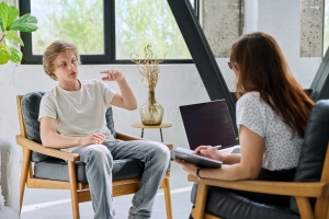 Young Boy Talking Comfortably with Therapist in Therapy Session