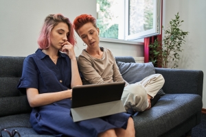 LGBTQ Couple Having Online Therapy at Home with Privacy