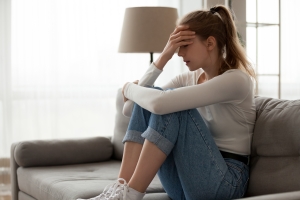 Upset Woman Frustrated by Self Sabotaging Sitting on Couch