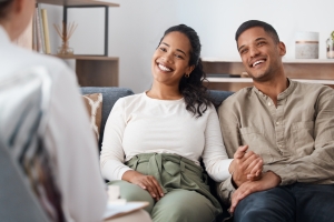 Happy Couple in Therapy and Marriage Counselling with Expert