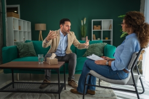 Man Expressing Anger to Therapist in Indivisual Therapy Session