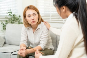 Psychologist Comforting Female with ADHD in Therapy Session