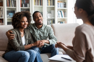 Smiling Couple Talking to Counselor After Successful Therapy